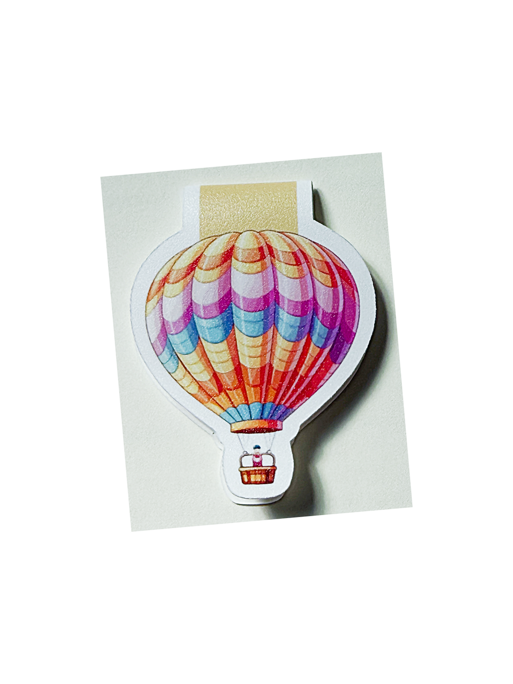 A die-cut magnetic bookmark shaped like a hot air balloon. 