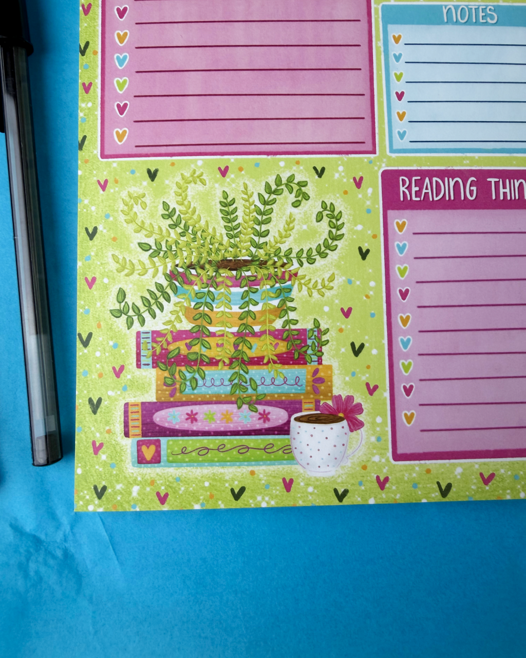 Colorful notepad with plant-themed design and various notes on a blue background