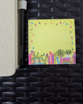 Colorful notepad with book and heart designs on a woven surface