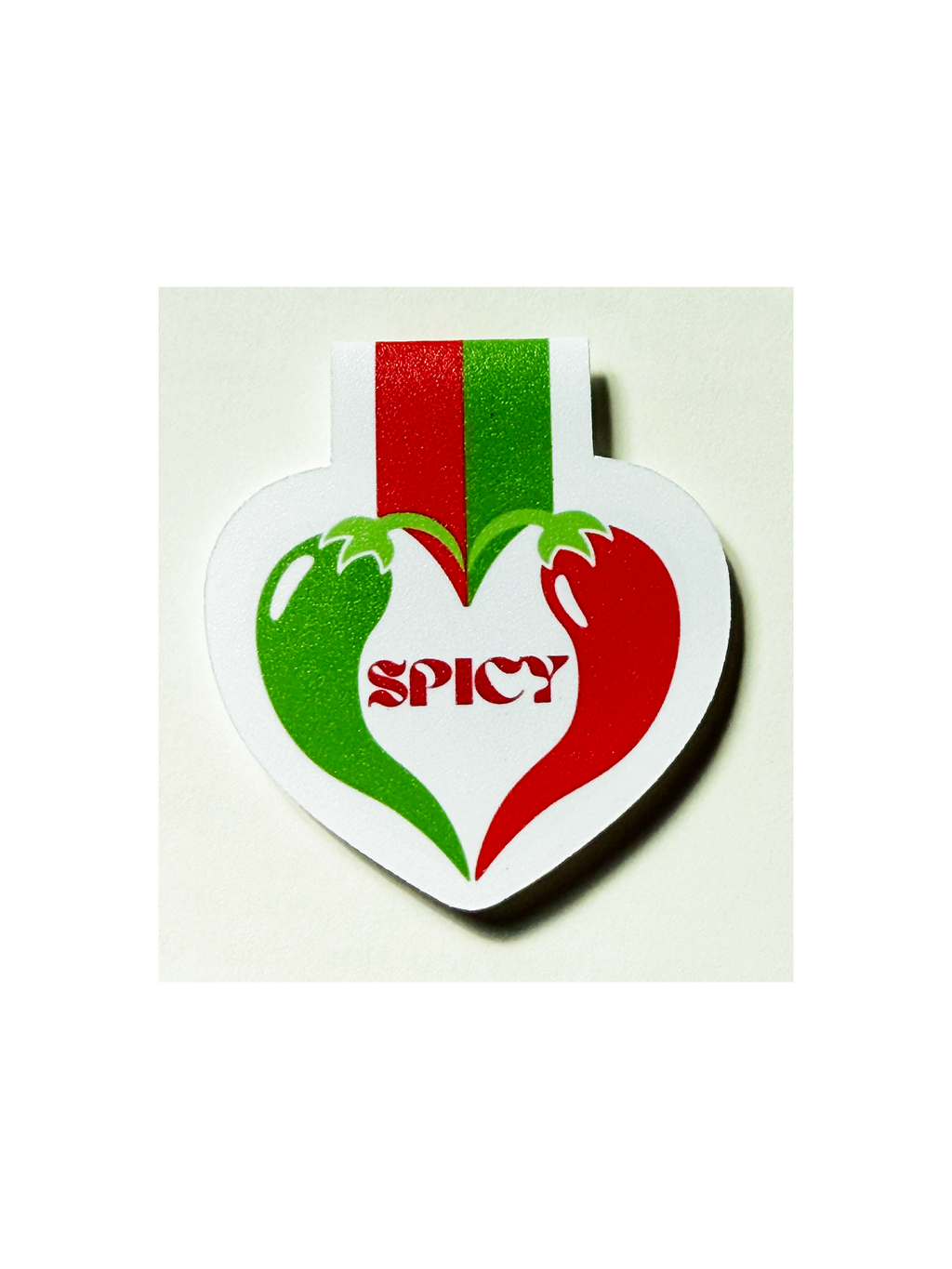 Heart-shaped spice tag with green and red design on a white background